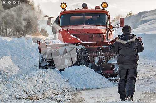 Image of Worker controls snow cleaning process