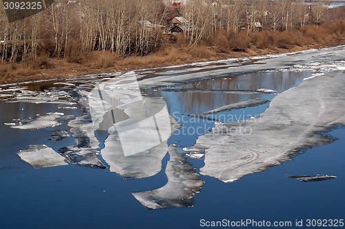 Image of Thawing ice floats down river