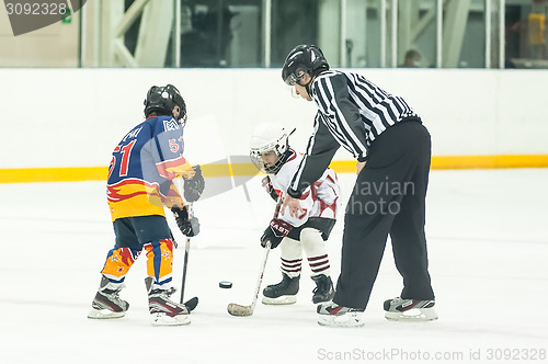 Image of Puck playing between players of ice-hockey teams