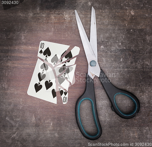 Image of Concept of addiction, card with scissors