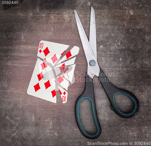 Image of Concept of addiction, card with scissors