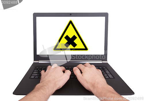 Image of Man working on laptop, irritation
