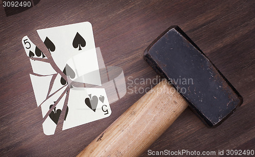 Image of Hammer with a broken card, five of spades