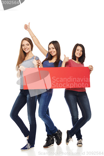 Image of Three girl friends with red banner