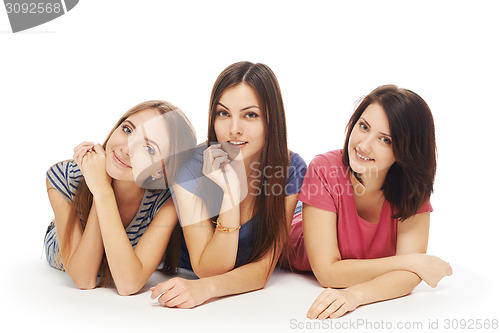 Image of Girls friends lying smiling on floor