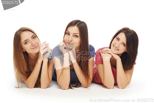 Image of Girls friends lying smiling on floor