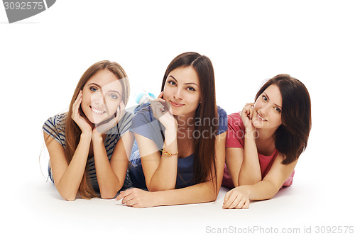 Image of Girls friends lying smiling on floor