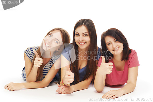 Image of Girls friends lying smiling on floor