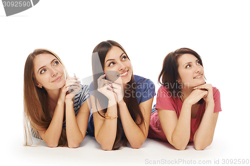 Image of Girls friends lying smiling on floor