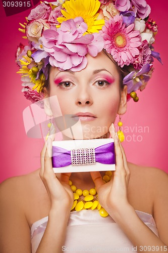 Image of Woman with gift box and flowers hair