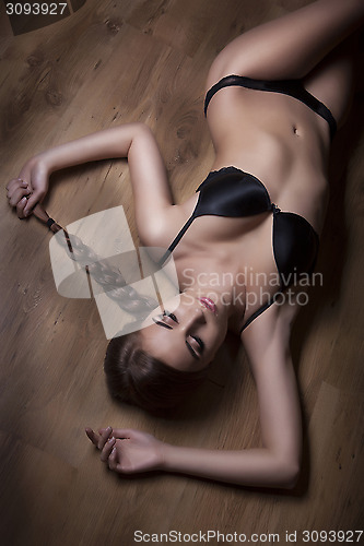 Image of attractive girl on timber floor