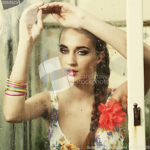 Image of girl behind wet window