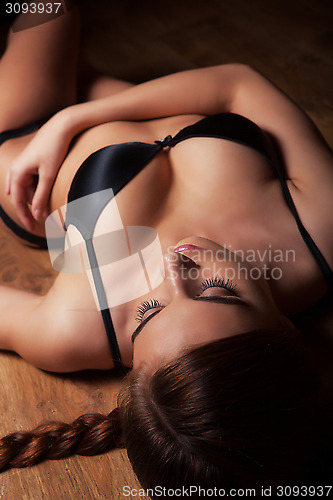 Image of attractive girl in lingerie on timber floor