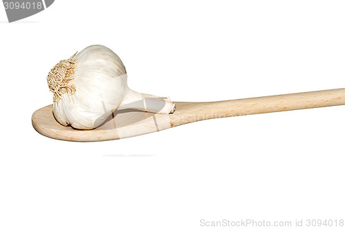 Image of Garlic on a light wooden spoon