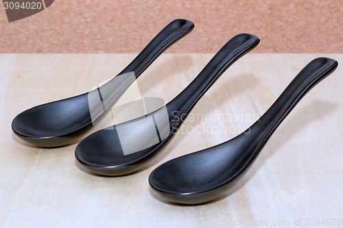 Image of Three ceramic black spoons