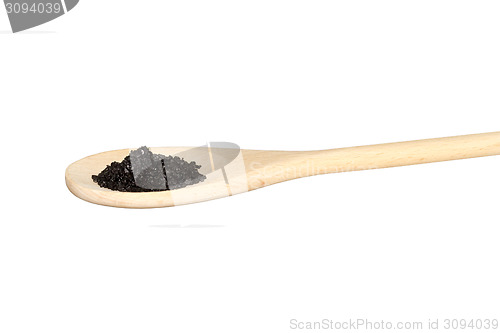 Image of Black salt on a light colored wooden spoon