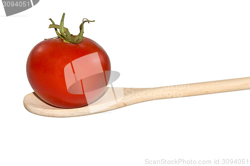 Image of Tomato on a light wooden spoon