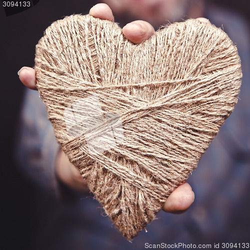 Image of Man holding heart in his hands