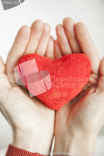 Image of love concept. holding a red heart in hands.