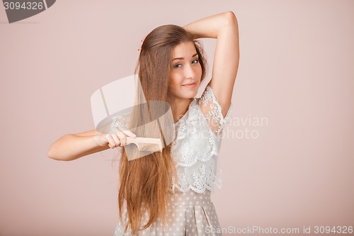 Image of Smiling Girl combs her hair
