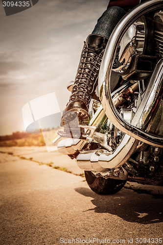 Image of Biker girl riding on a motorcycle