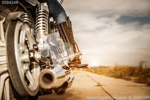 Image of Biker girl riding on a motorcycle