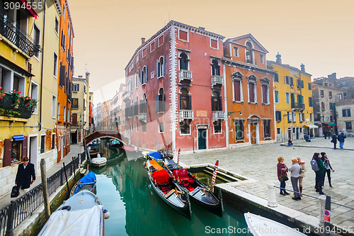 Image of Gondolas moored along water canal in Venice