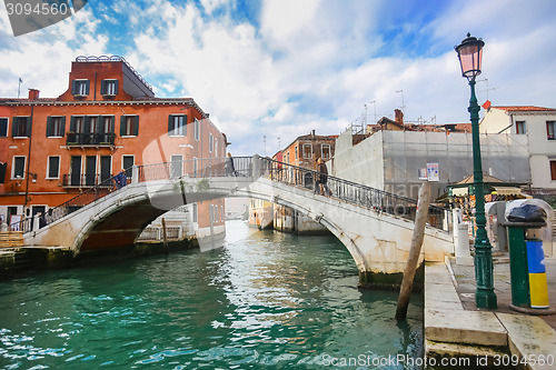 Image of Tourists walking on bridge in Venice