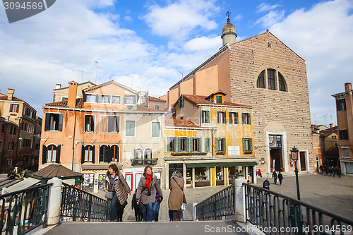 Image of Tourists walking over bridge in Venice