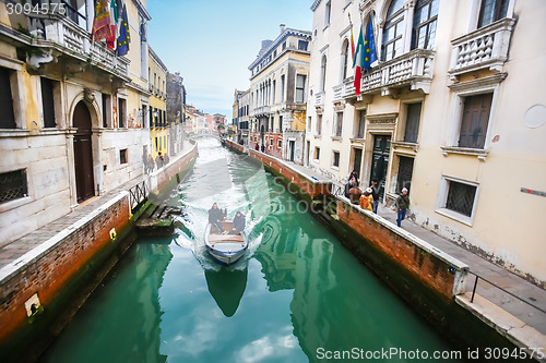 Image of Boat sailing in italian water canal