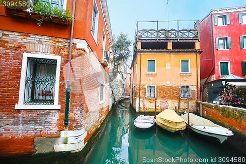 Image of Boats parked next to buildings 