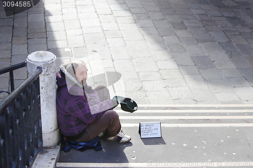 Image of Beggar sitting on stairs in Venice