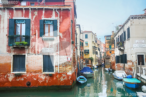 Image of Boats parked in italian water canal