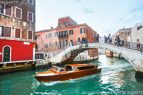 Image of Ship sailing under bridge in Venice