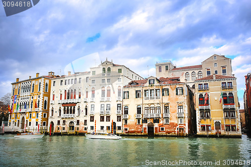 Image of Boats sailing next to buildings