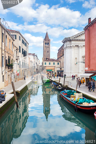 Image of Boats moored along water canal in Venice 