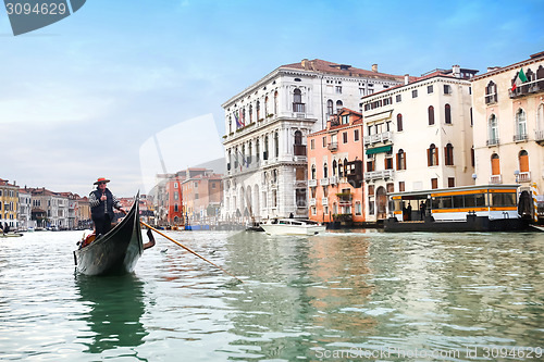 Image of Gondola sailing in italian water canal