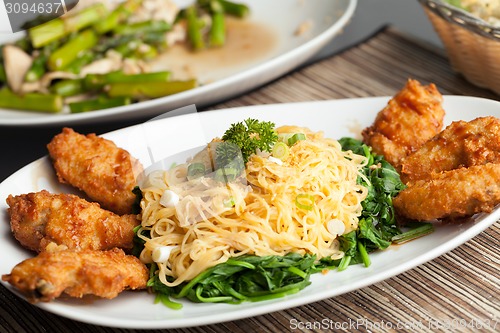 Image of Chicken Wings with Noodles and Spinach