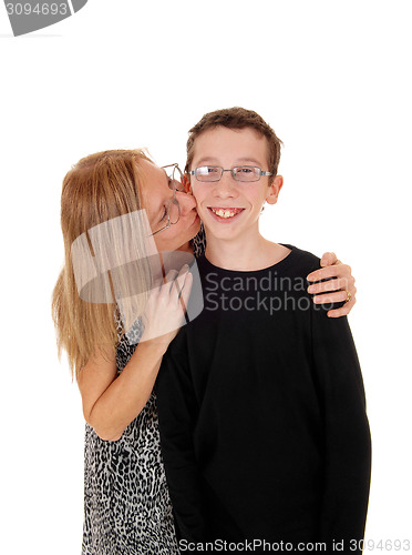 Image of Mother kisses her son.