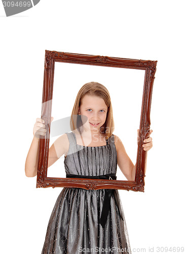 Image of Pretty girl holding picture frame.