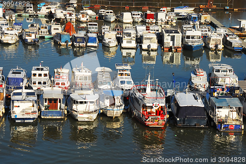 Image of Various parked boats in row