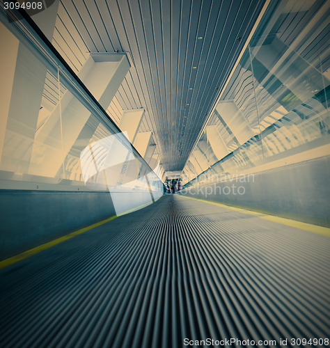 Image of moving blue escalator