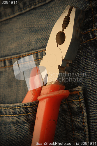 Image of pliers in jeans pocket