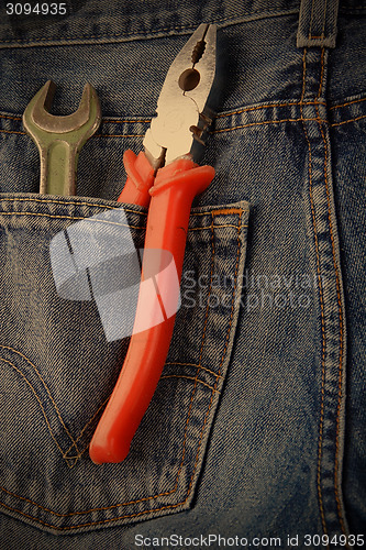 Image of wrench and pliers in jeans pocket