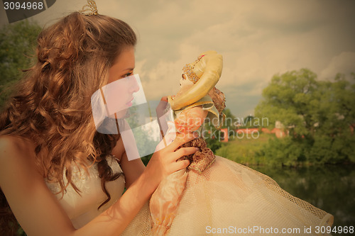 Image of princess plays with loved doll