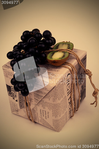 Image of gift, stylishly packaged in an old newspaper box