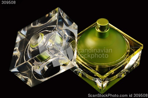 Image of Opened perfume bottle over black