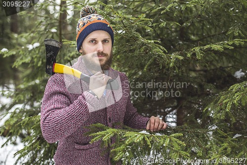 Image of Lumberjack near the christmas tree in forest