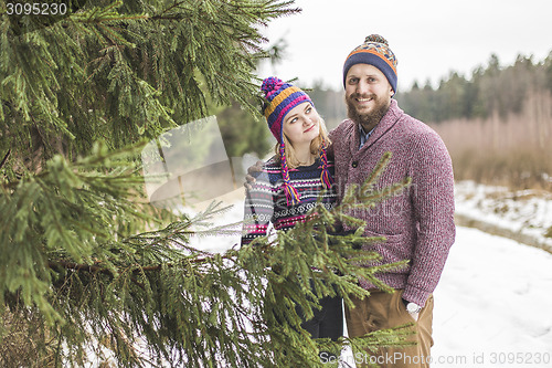 Image of Young couple hugging in winter forest