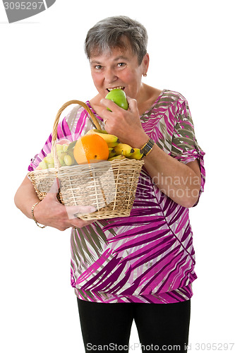 Image of Senior woman biting into an apple